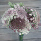 Close-up of Dara Queen Anne's Lace bouquet showcasing lacy umbels with burgundy centers on a gray wooden background