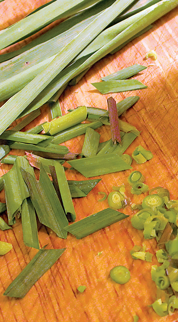 Chopped lemongrass on a wooden cutting board