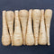 Top-down view of five Warrior parsnip roots showing smooth creamy white tapered roots on black background