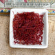 Front view of saffron crocus bulbs showcasing bulb shape and papery tunics on white background