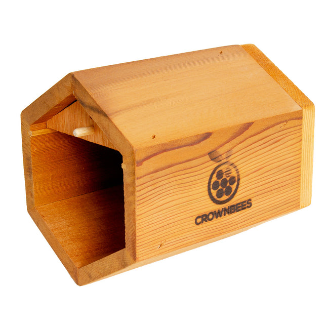 Three-quarter view of Villa Bee House showcasing cedar six-sided body with open front, entrance perch, and logo on white background