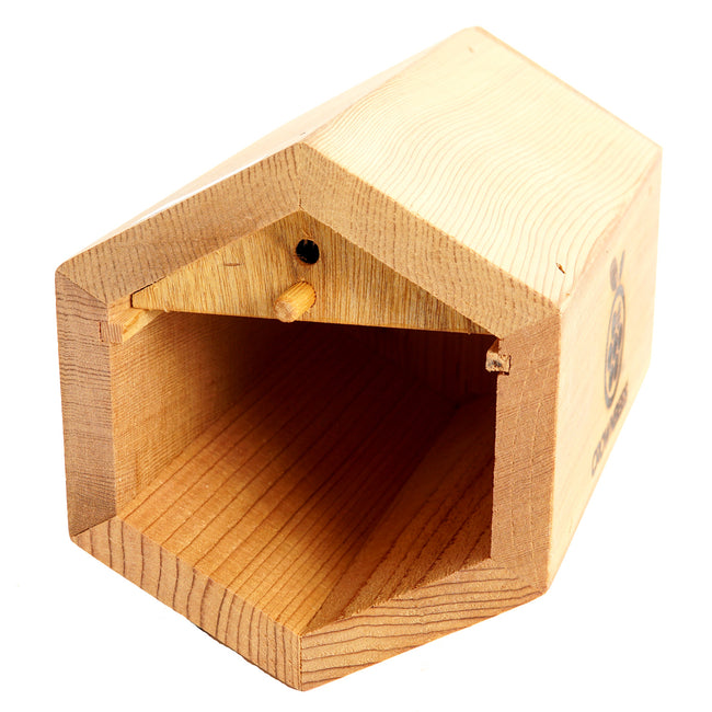 Front view of Cabana Bee House showing hexagonal cedar opening and hollow interior on white background