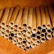 Close-up of spring natural reeds showing bundled hollow 6-inch tubes for bee houses on a wooden background