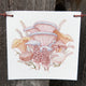 Front view of Produce Flags showcasing watercolor vegetable paintings on seven small canvas flags strung on hemp cord