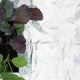 Close-up of Silver Mulch under potted plants showcasing reflective silver plastic ground cover