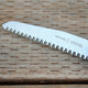 Opinel No 12 saw blade on a wooden surface