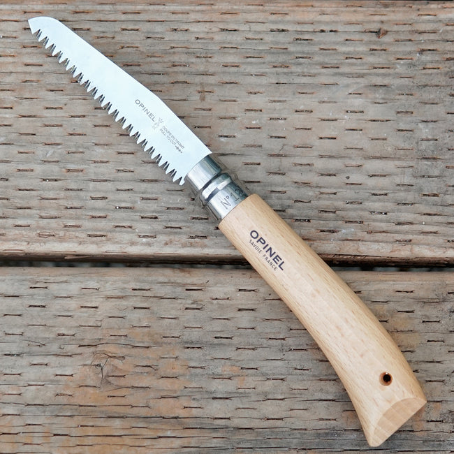 Opinel No 12 saw with wooden handle on a wooden surface