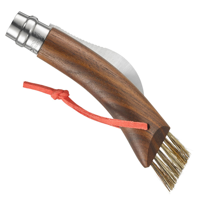 Angled view of Opinel mushroom knife showing curved black walnut handle, folded stainless blade, boar-hair brush and orange lanyard on white background