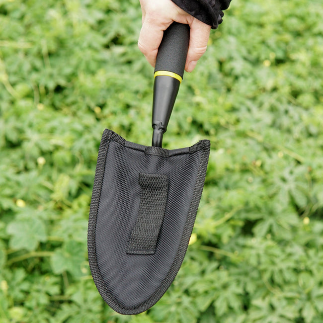 Top view of Handy Trowel showing high-carbon steel curved blade and ergonomic handle on grass