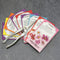 Front view of Easy-Care Flower Cutting Garden Kit showing nine colorful seed packets fanned with snips.