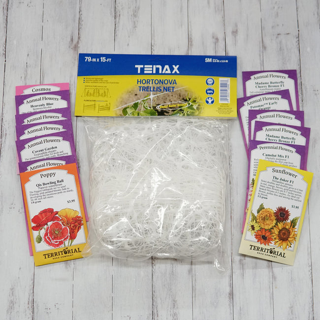 Front view of Favorite Cutting Flowers garden kit showing bundled trellis netting and assorted seed packets on a white wood background