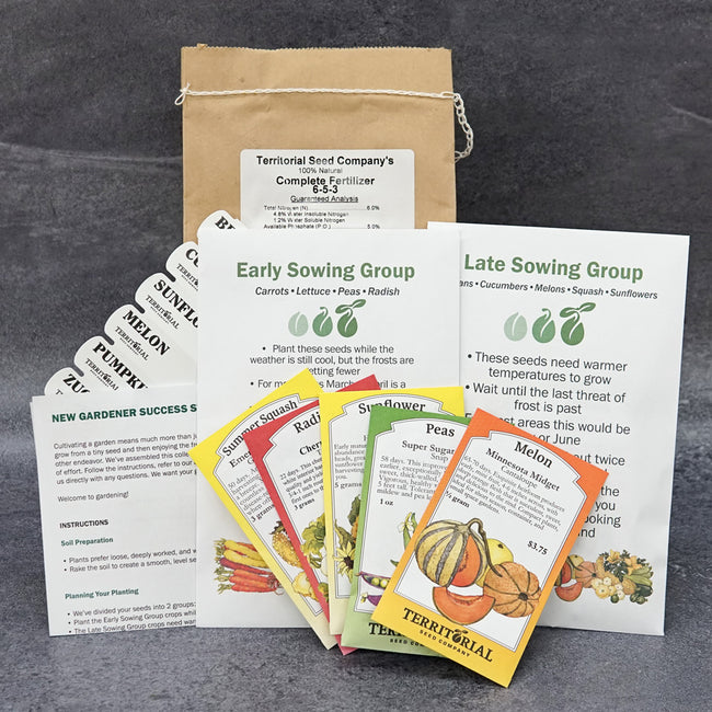Front view of New Gardener Success Starter kit showing seed packets, plant labels, instruction sheets, and box on white background