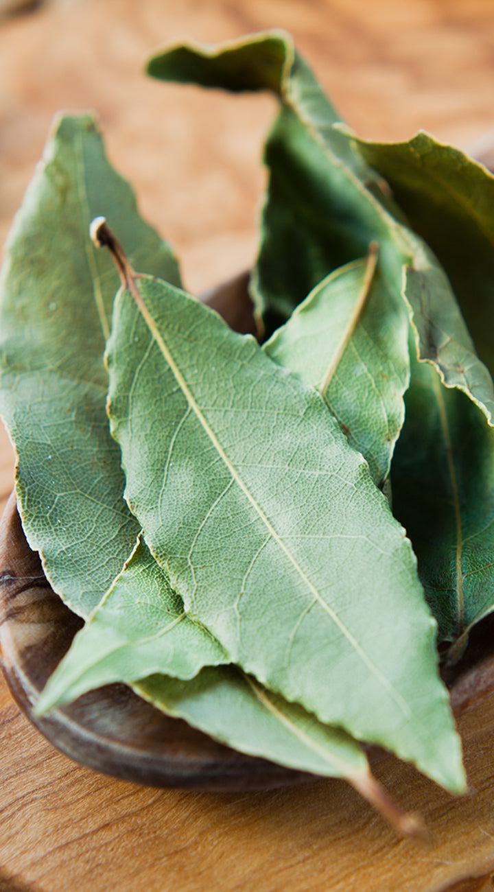 Bay leaves on a wooden surface