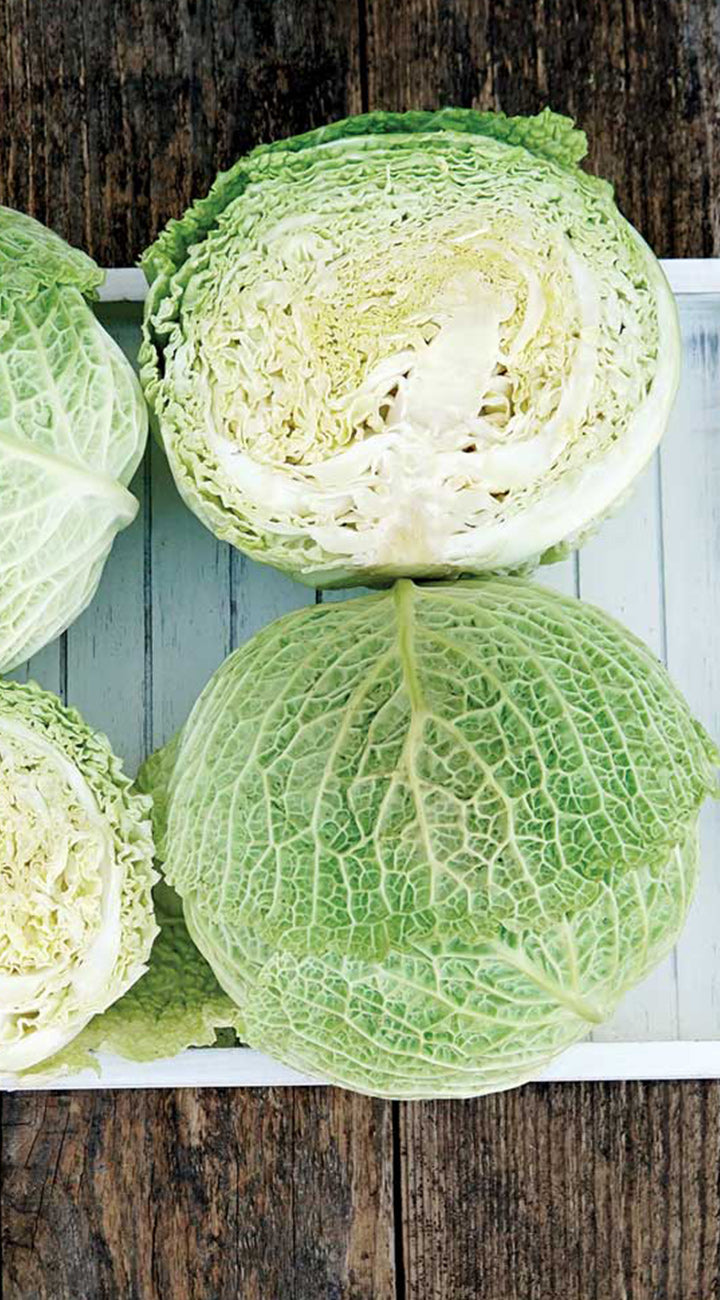 Cabbage halves on a wooden surface