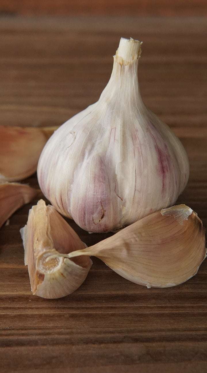 Garlic bulb and cloves on a wooden surface