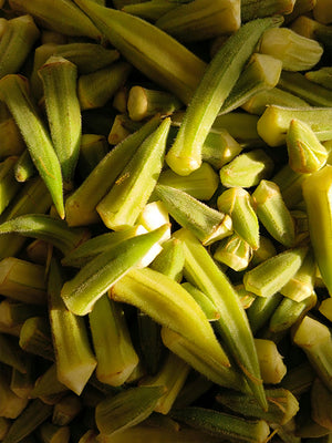 Close-up of green okra pieces, with a blurred background.