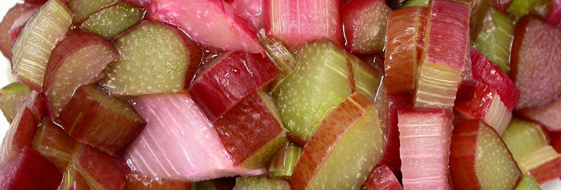 Sliced rhubarb pieces in red and green on a white background