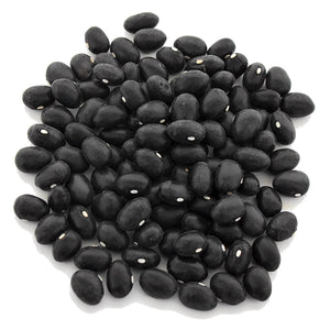 Top-down view of Black Coco dry shelling bean seeds showing smooth black seeds with white hilums on a white background