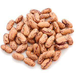 Close-up of Missouri Bill dry shelling beans showing cream-colored seeds with crimson streaks on white background