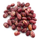 Top view of cranberry beans showing maroon and cream speckled dry seeds on white background
