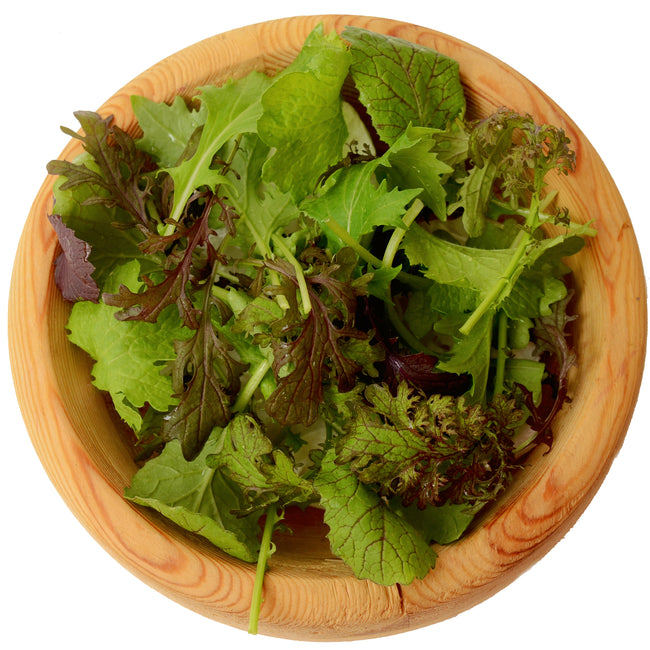 Overhead view of Market Mustard Mix in a wooden bowl showing red and green frilly mustard greens