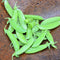 Top-down close-up of Super Sugar Snap pea pods showing plump, bright green, stringless pods in a rust-colored bowl