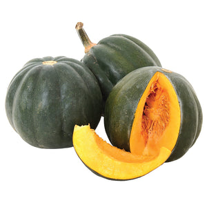 Front view of three Honey Bear acorn winter squashes, one cut to show bright orange flesh, on white background