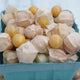 Close-up of Pineapple ground cherries showcasing ripe golden berries and pale papery husks in a blue pint basket