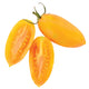 Close-up of Blush cherry tomatoes showing elongated golden fruit with ruby red streaks on white background