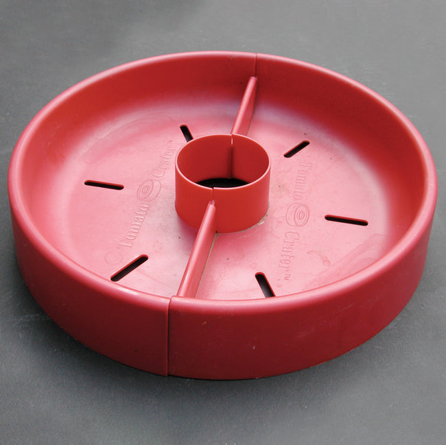 Top view of Tomato Crater cloche showing red circular plastic ring with central planting hole and radial drainage slots on white background