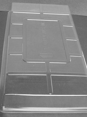 Angled view of 2-inch clear plastic propagation dome flat insert showing ventilation slots on white background