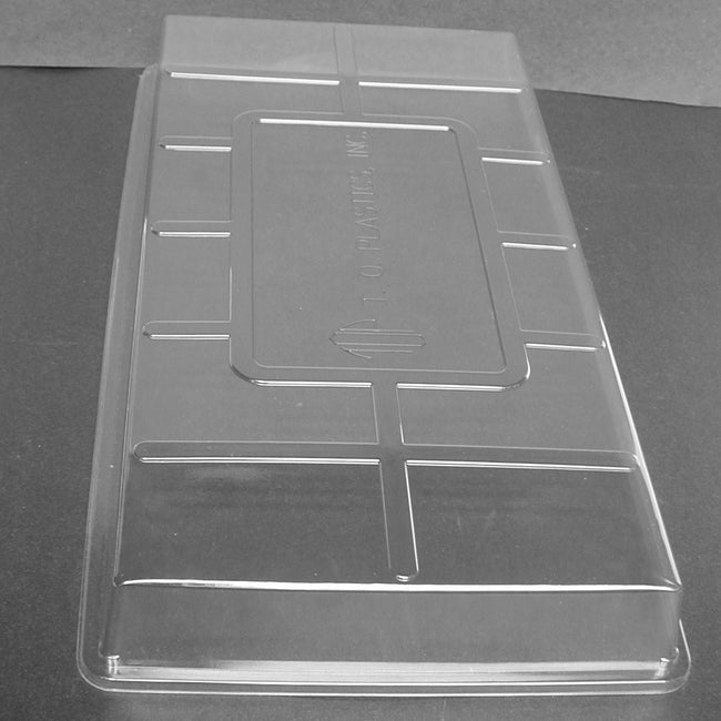 Angled view of 2-inch clear plastic propagation dome flat insert showing ventilation slots on white background