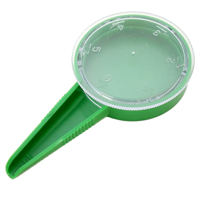 Top-down view of green Dial Seed Sower showcasing adjustable numbered dial (0-5) and pointed spout on white background