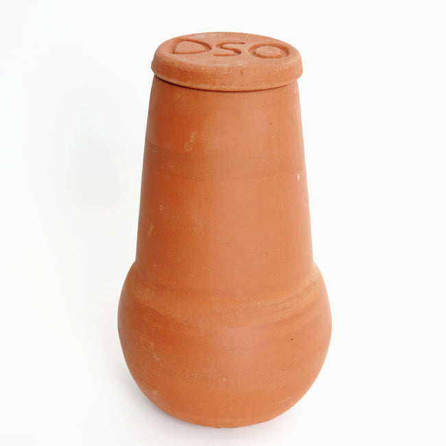 Front view of Medium olla irrigation pot showcasing unglazed terracotta body and protective lid on white background