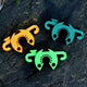 Front view of C-Bite stake clips showing three interlocking clips in orange, lime, and dark green on a dark background
