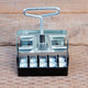 Front view of Micro 20 soil blocker showing metal 20-cube press with top handle on a wooden surface