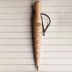 Angled view of DeWit 12-inch ash dibber showcasing brass tip, engraved inch markings, and leather hanging loop on white background