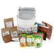 Front view of Perpetual Garden Collection bucket with assorted vegetable seed packets, planting supplies, and booklet on white